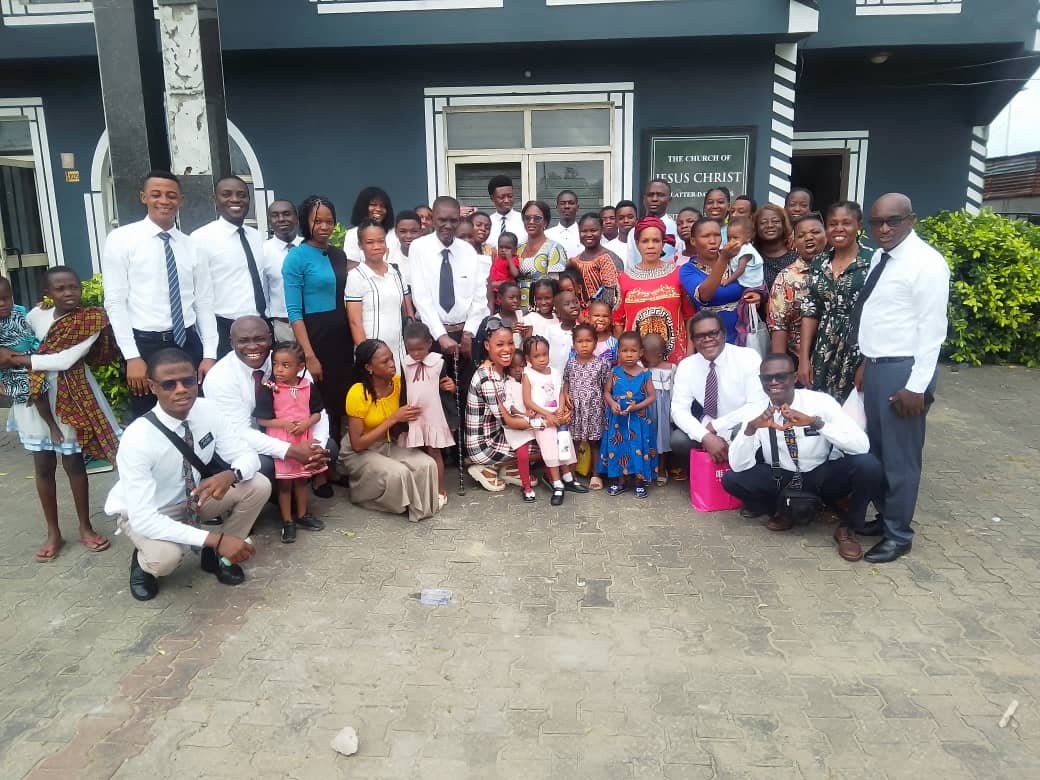 A group of church members standing together outside the chapel building
