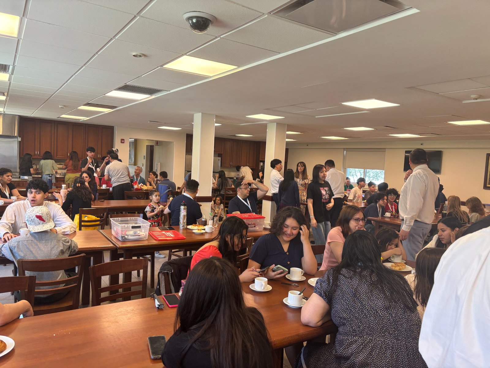 Church members gathered around a table sharing a breakfast meal