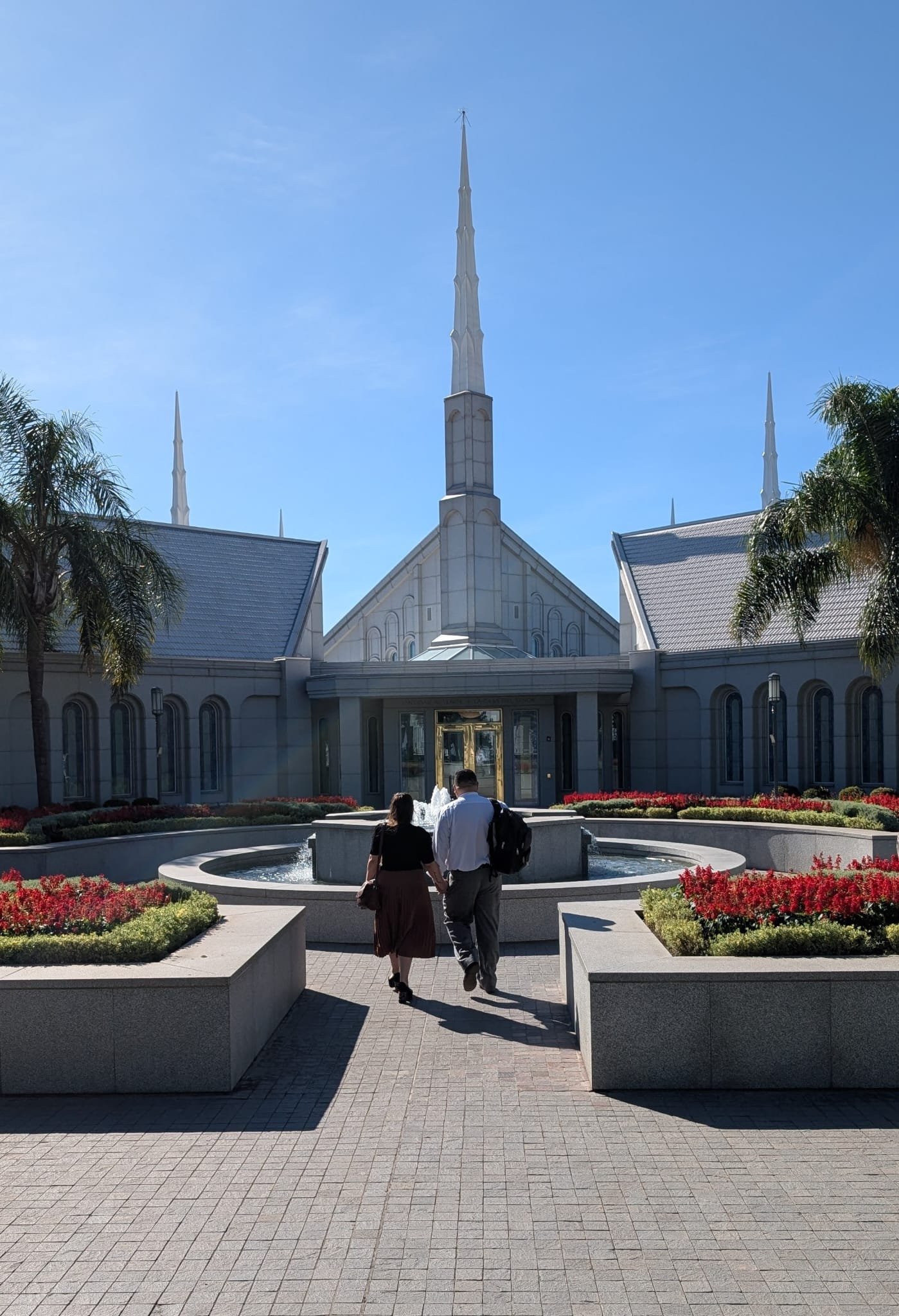 A couple walking hand in hand toward the temple